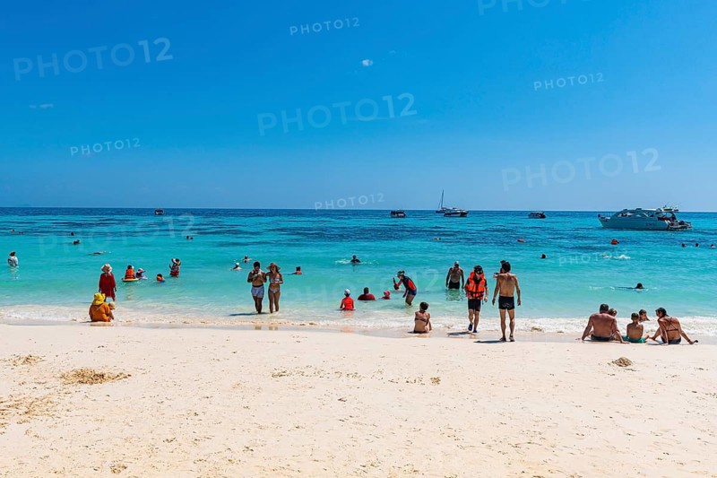 Tourists on a white sand beach and turquoise water, Koh Rok
