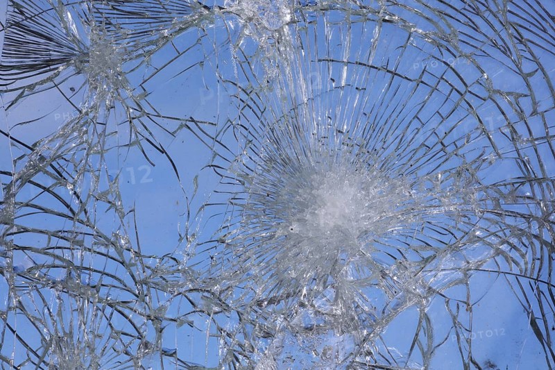 Shattered and broken glass pane with fractures, cracks and shapes