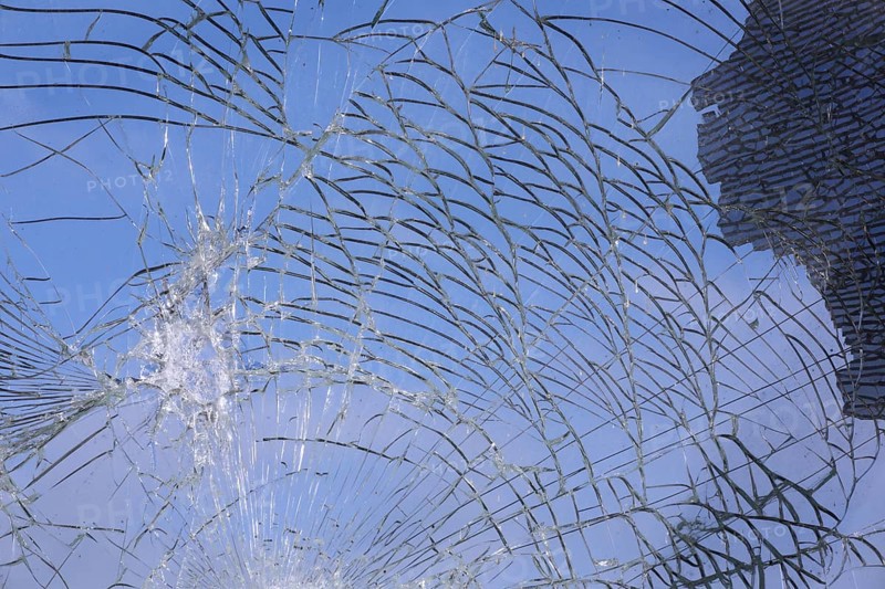 Shattered and broken glass pane with fractures, cracks and shapes
