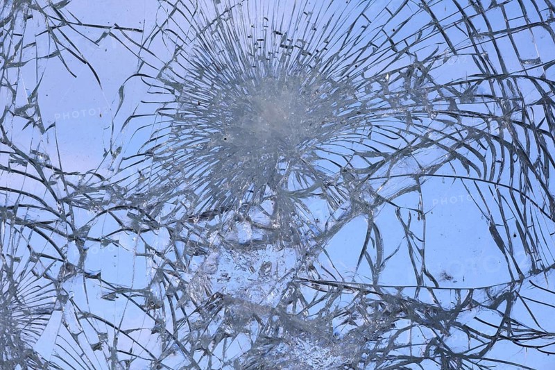 Shattered and broken glass pane with fractures, cracks and shapes