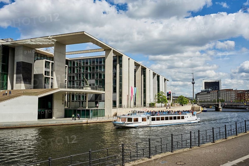 Marie-Elisabeth-Lueders-Haus designed by architect Stephan Braunfels, in front the Spree with a pleasure boat