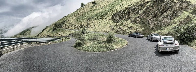 Three Porsche sports cars in front 911 GT3 behind Cayman 718 in the background 911 997 driving through a bend at Passo della Teglia, Ligurian Alps