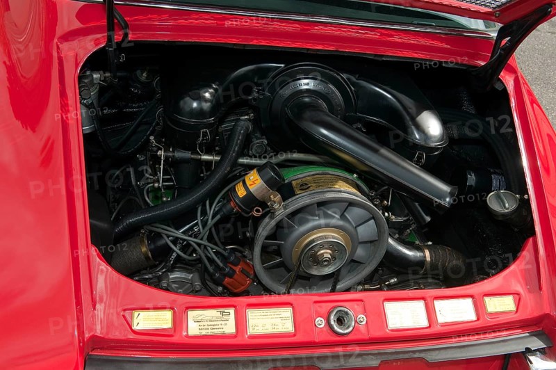 View into engine compartment with air-cooled boxer engine of classic vintage car Classic Car Porsche 911 E Targa from the 60s, Techno Classica fair