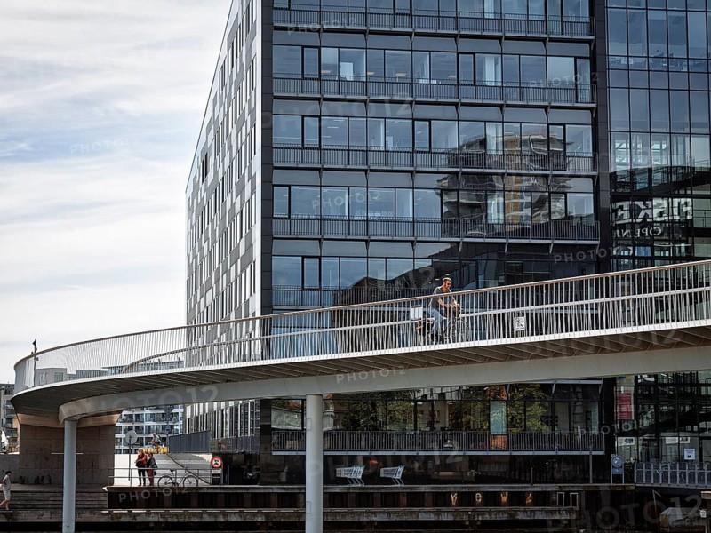 Cyclists on bridge over inner harbour basin, Cykelslangen bicycle bridge