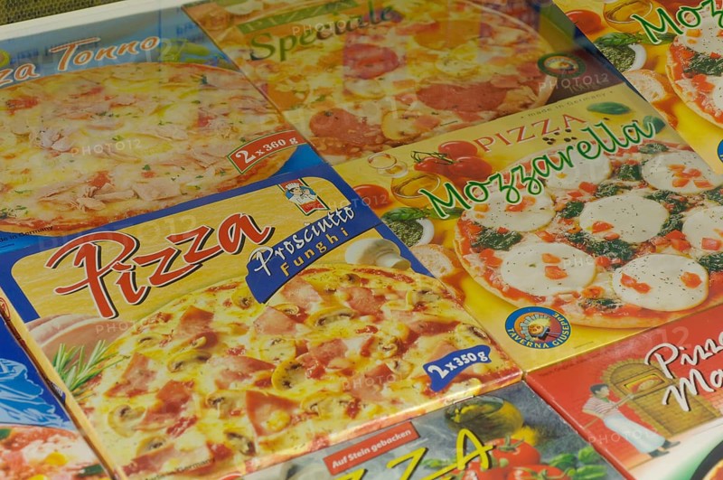 Frozen pizza in the freezer in a supermarket,