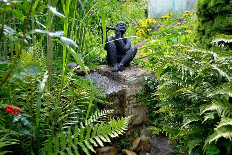 Black Garden Figurine with Flute by the Garden Stream