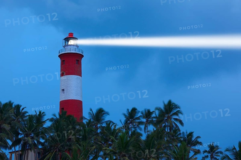 Lighthouse in night with light beam