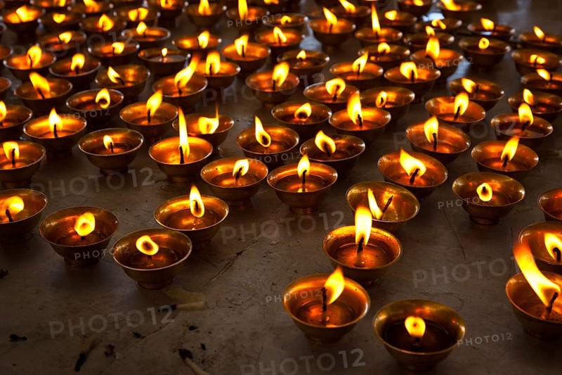 Burning candles in Buddhist temple. Tsuglagkhang complex