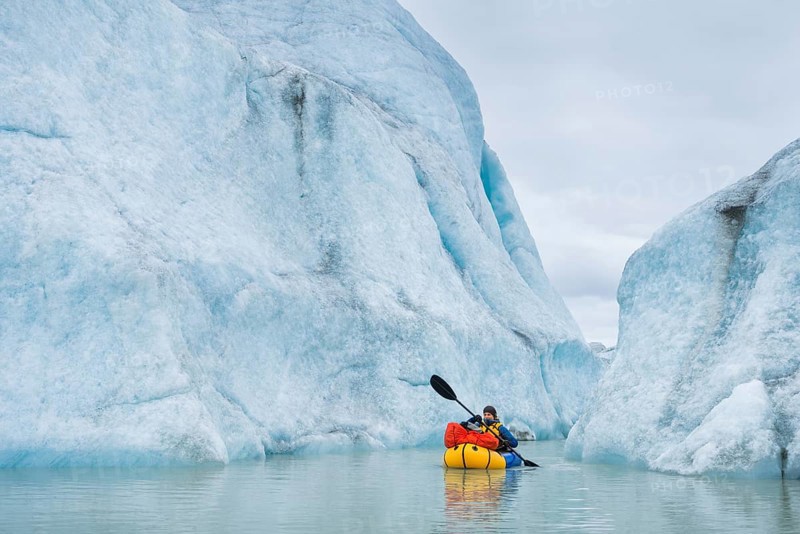 Woman with packraft at sea