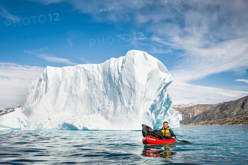Man with packraft on fjord