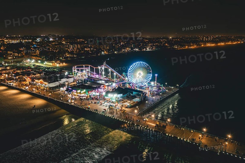 Circa November 2019: Santa Monica Pier at Night in super colourful lights from Aerial Drone perspective in Los Angeles