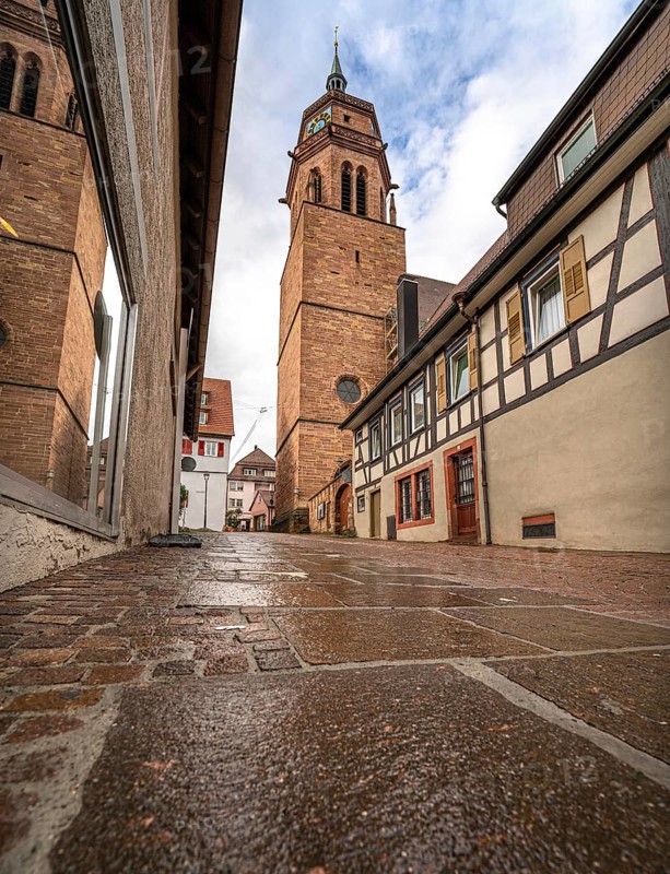 Tunnel view of the church through an alley of half-timbered houses