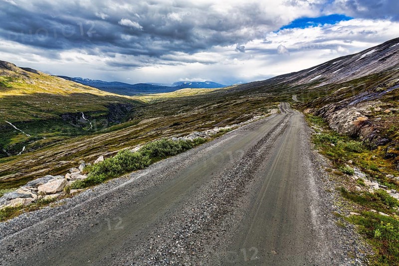 Gravel road through vast barren mountain landscape