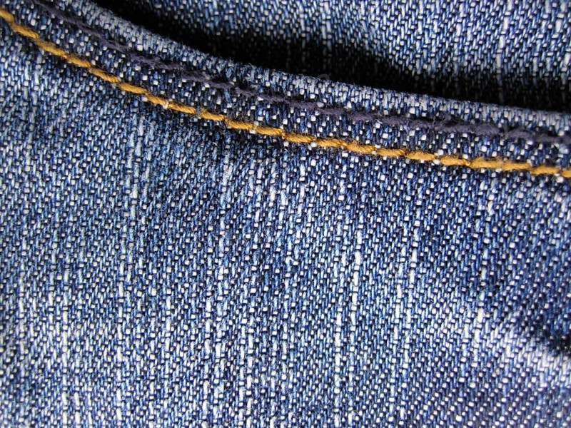 Denim jeans as blue background. With trouser pocket shown in full image in the plane