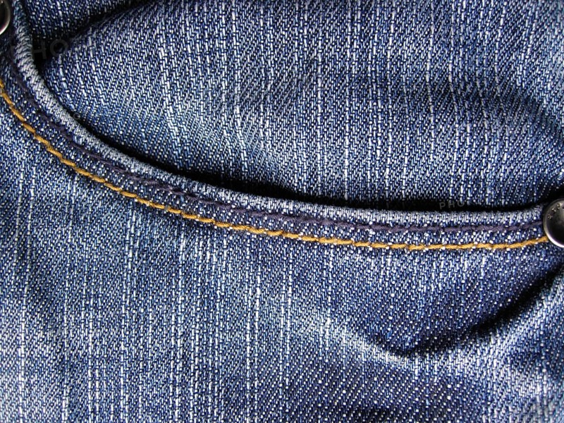 Denim jeans as blue background. With trouser pocket shown in full image in the plane