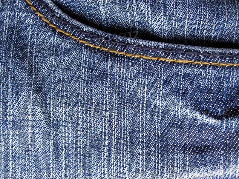 Denim jeans as blue background. With trouser pocket shown in full image in the plane