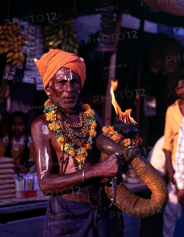 A devotee holding fire torch