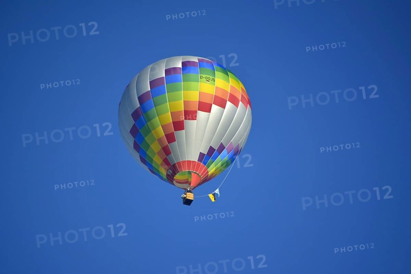 Beautiful colourful hot air balloon in the air with blue sky