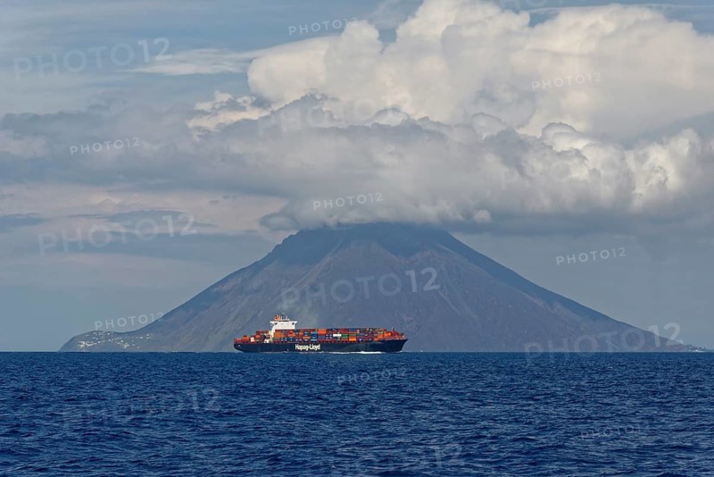 Container ship in front of Stromboli volcano and island