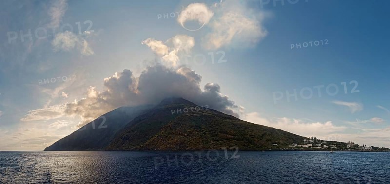 Stromboli volcano and island with the small fishing village of San Vincenzo with a circular smoke ring