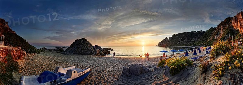 Panorama on the sandy beach and bay Capo Vaticano at sunset