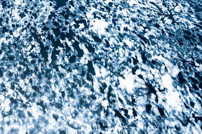 Droneview on a lake with floating ice sheet in the montain range Hemsedalfjell