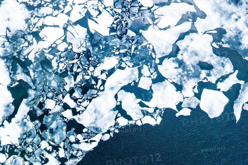 Droneview on a lake with floating ice sheet in the montain range Hemsedalfjell