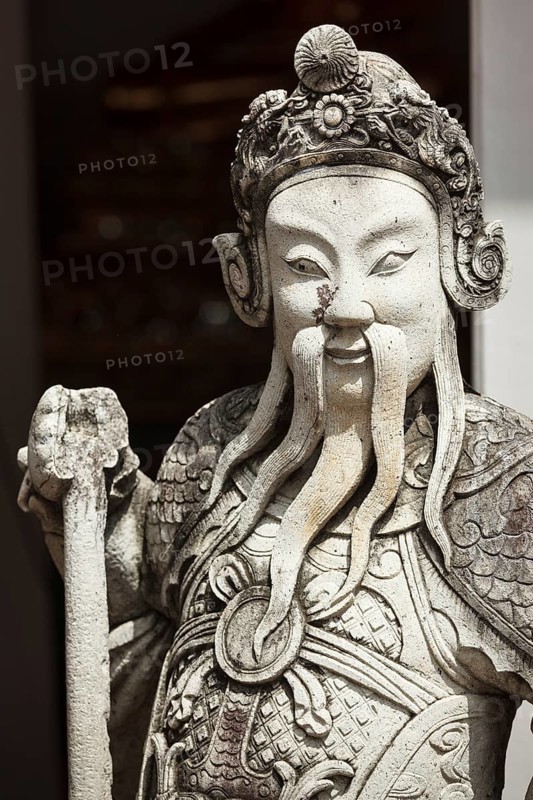 Chinese stone guardian statue close up in Wat Pho Buddhist Temple