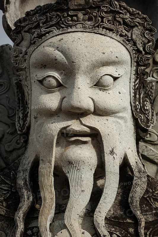 Wat Pho Chinese stone guardian face close up