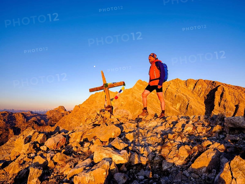 Mountaineers on the summit of the Kleiner Watzmann in the morning light