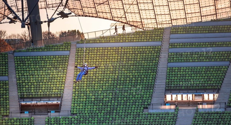 Woman swinging on a zip line above the Olympic Stadium