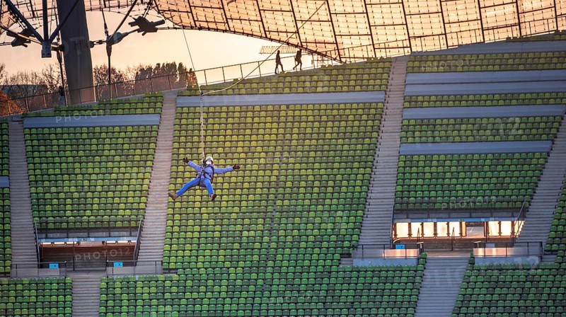 Woman swinging on a zip line above the Olympic Stadium