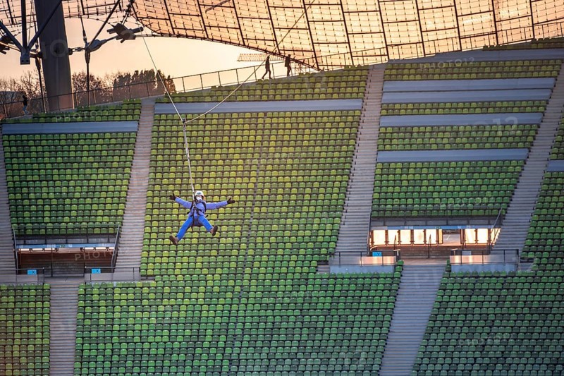 Woman swinging on a zip line above the Olympic Stadium