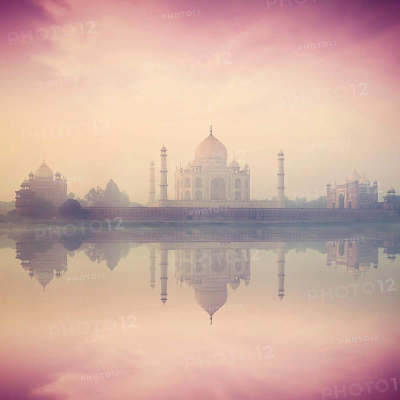 Vintage retro hipster style image of Taj Mahal on sunrise sunset reflection in Yamuna river panorama in fog