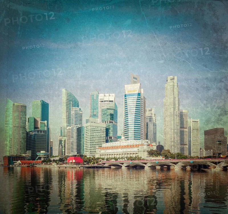 Vintage retro hipster style travel image of Singapore business district skyscrapers and Marina Bay in day