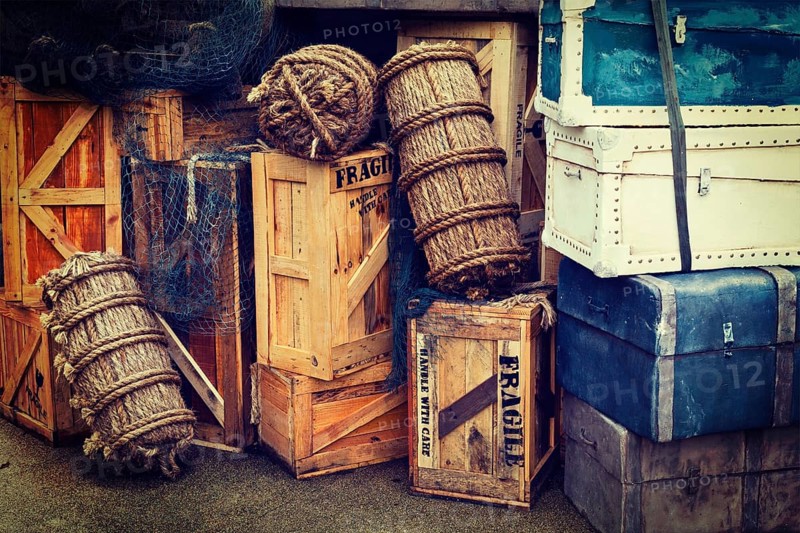 Retro hipster style travel image of vintage luggage and crates