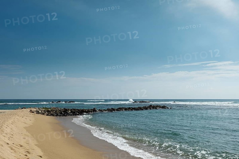 Wave breaker on beach. Mirissa