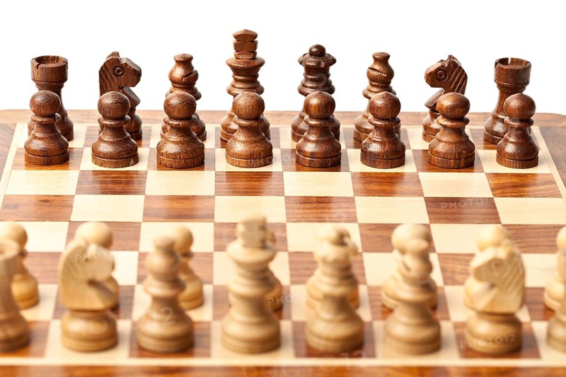 Wooden chess pieces on chessboard. Selective focus