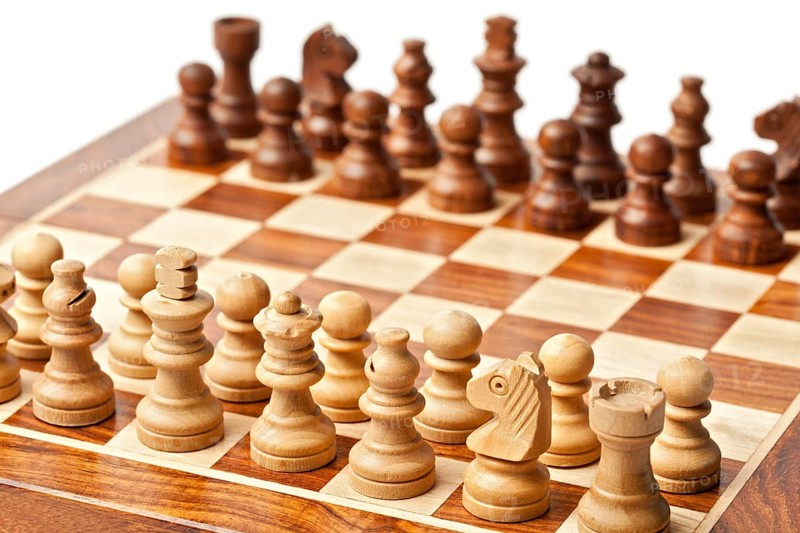 Wooden chess pieces on chessboard. Selective focus