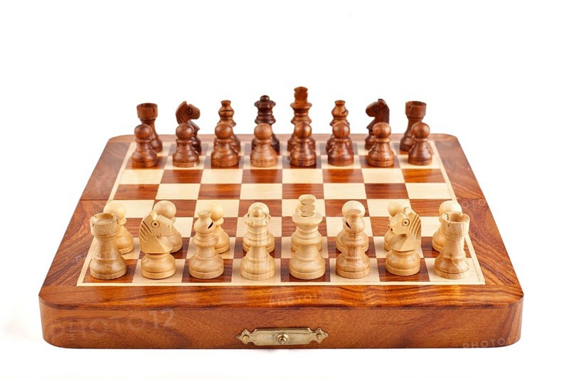 Wooden chess on chessboard ready to play
