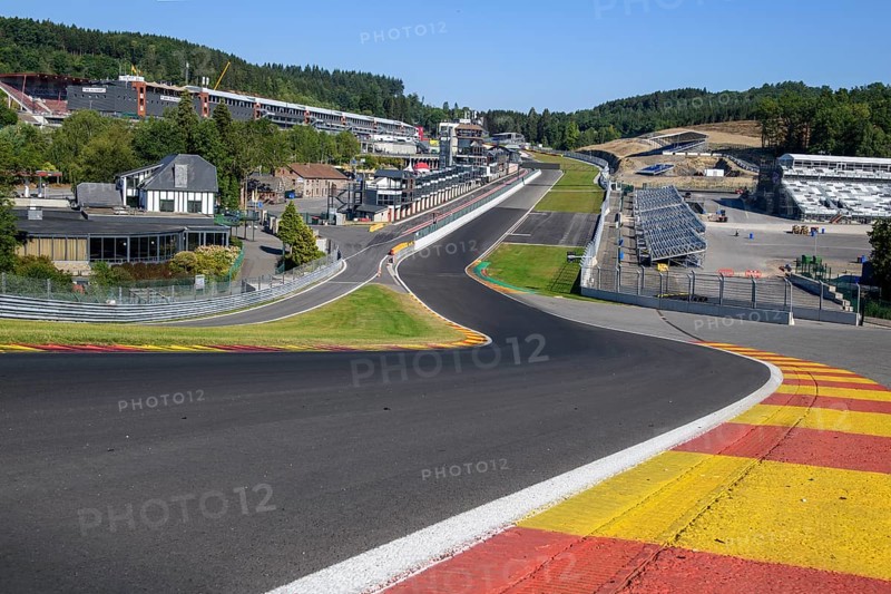 View from 40 metres high hilltop above the steep Raidillon driveway in the foreground to the dangerous Eau Rouge bend in the background of the Spa Francorchamps race track without racing cars