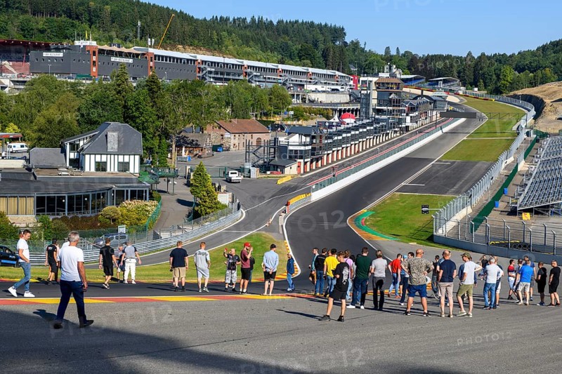 Trackday participants visit dangerous Eau Rouge courage curve get information from guided tour of FIA Formula 1 circuit