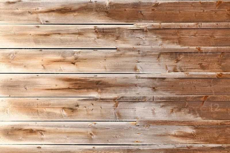 Horizontal weathered wood background with brown colored planks with fading colors