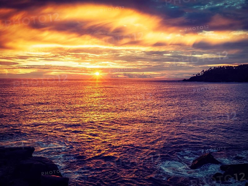Vintage retro effect filtered hipster style image of romantic ocean sunset with dramatic sky. Mirissa