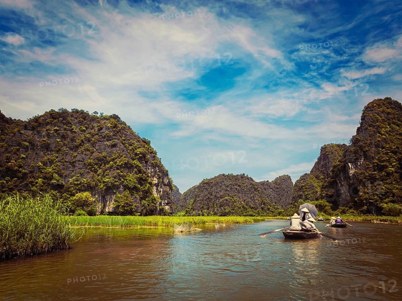 Vintage retro effect filtered hipster style image of tourists on boats in Tam Coc-Bich Dong Ngo Dong river in popular tourist destination near Ninh Binh