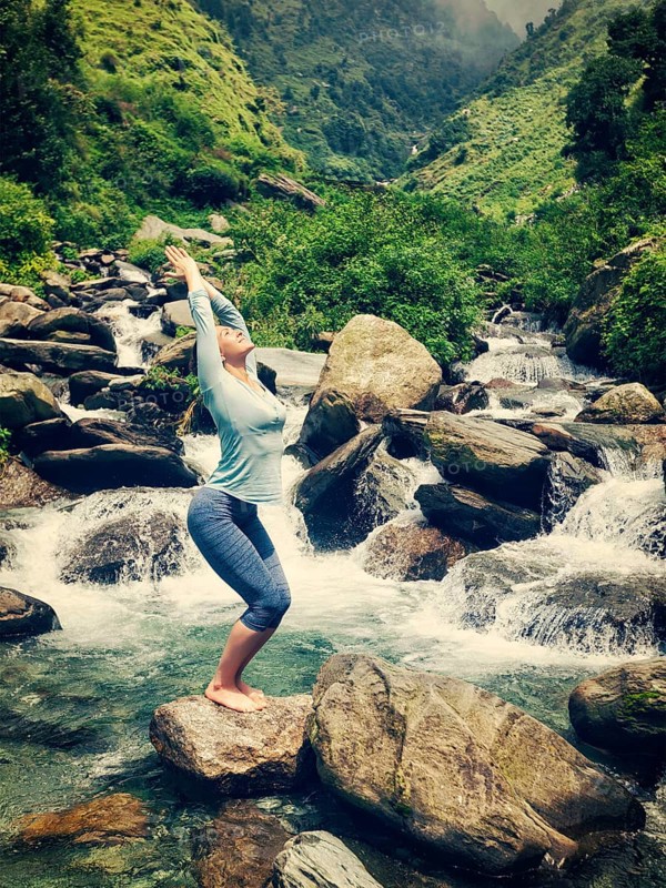 Vintage retro effect hipster style image of sporty fit woman doing yoga asana Utkatasana