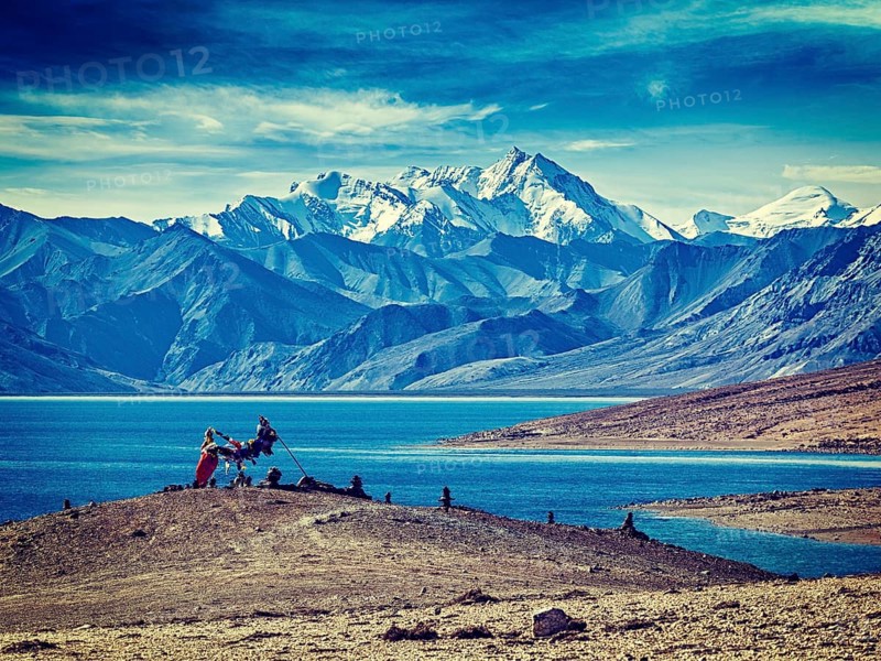 Vintage retro effect filtered hipster style image of Buddhist prayer flags lungta at Himalayan lake Tso Moriri in the morning. Korzok