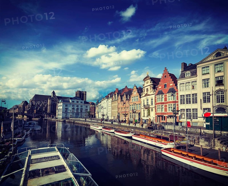 Vintage retro hipster style travel image of travel Belgium medieval european city town background with canal. Koperlei street