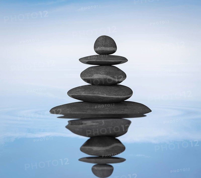 Zen stones in water with reflection balance concept