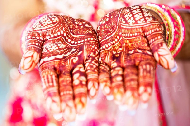 Beautiful henna design on hand of Hindu bride